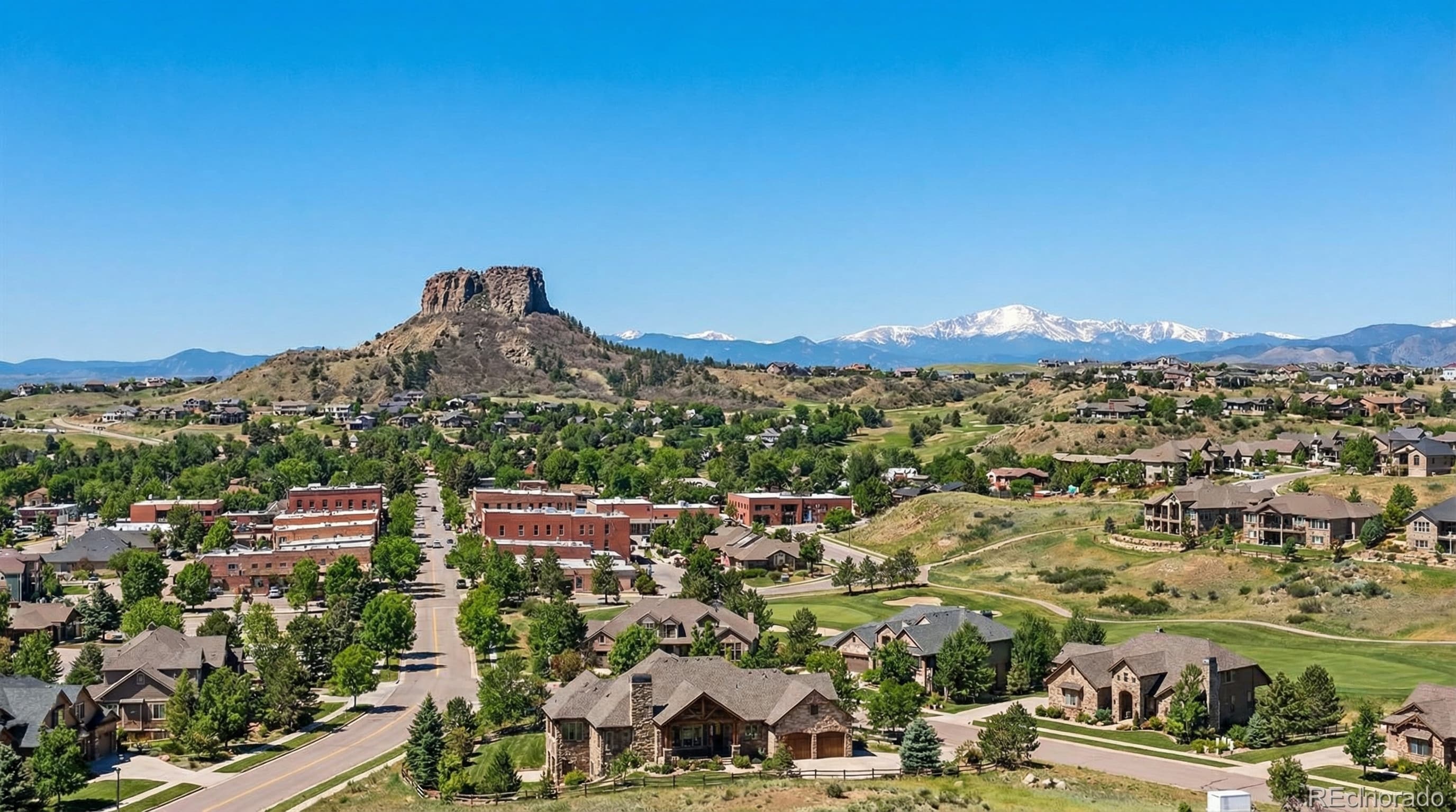 Castle Rock Colorado with iconic rock formation, charming downtown shops, and Douglas County mountain views